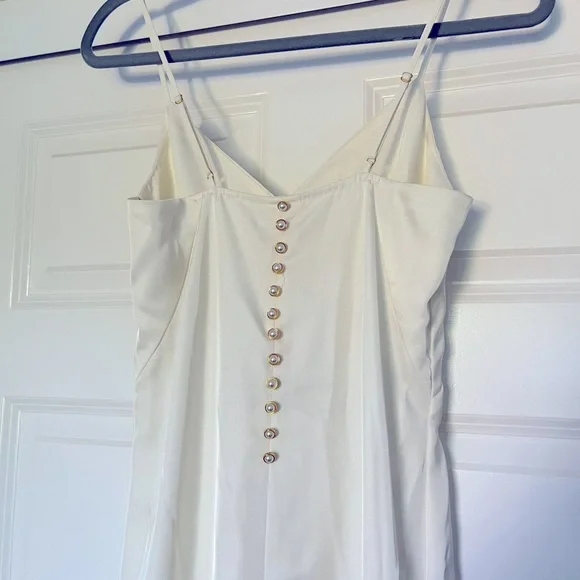 Brand new. Never worn. H&M cream white midi dress. Pearl & gold buttons on  back.